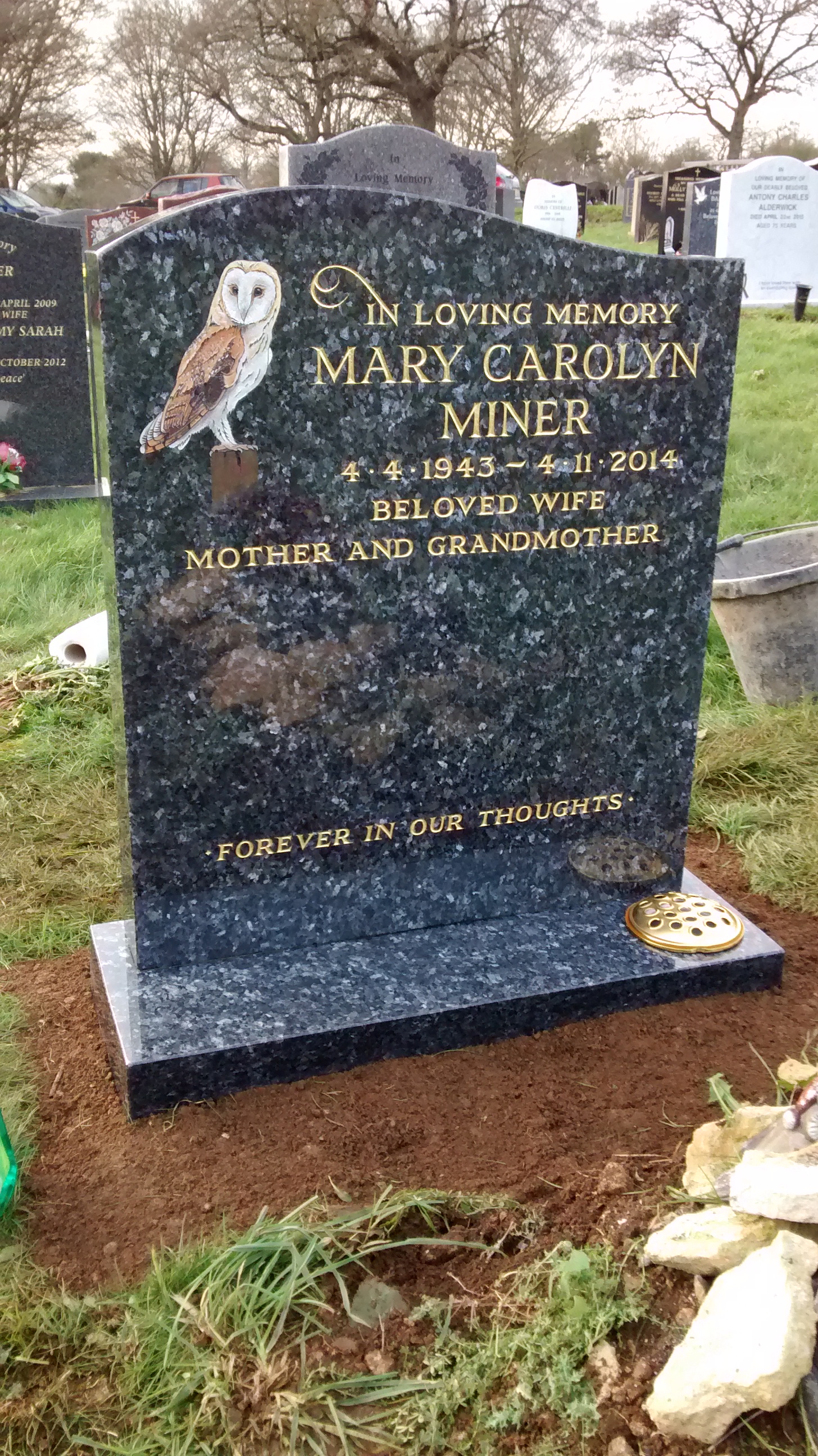 blue Pearl granite lawn headstone with owl design